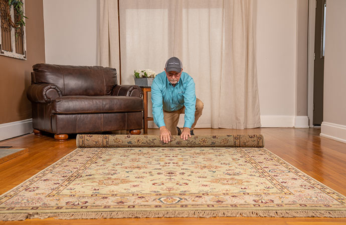 Worker placing rug on the floor