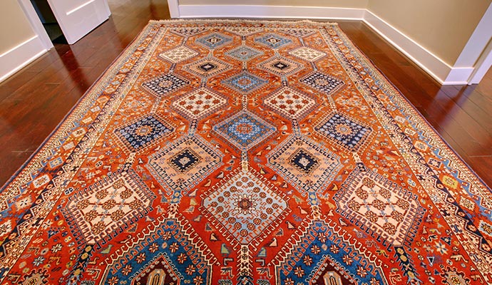 Antique rug placed on a wooden floor