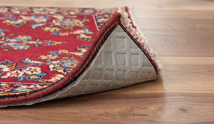Cushioned non-slip rug pad under an oriental rug