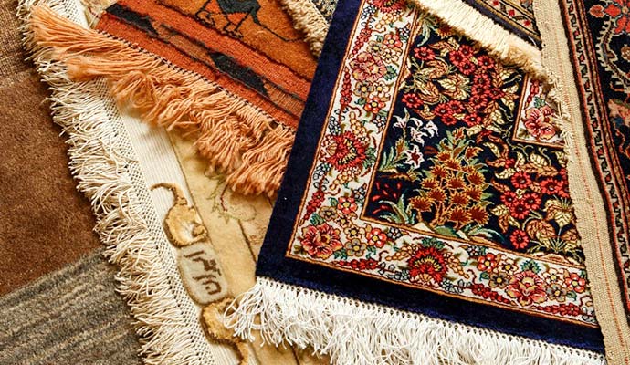 Delicate handwoven silk rug with fringe details