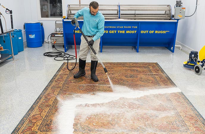 Professional worker cleaning rug in Cincinnati