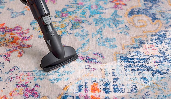Low moisture dry cleaning attachment on an area rug