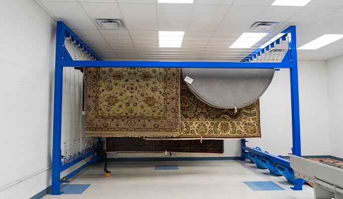 Rugs hanging on a drying rack