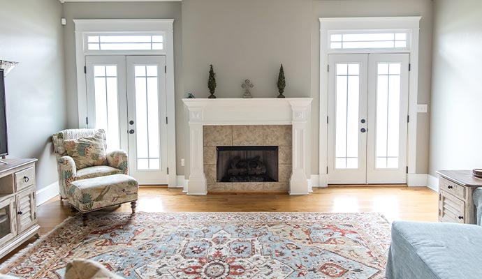 Traditional oriental area rug in formal living room with fireplace