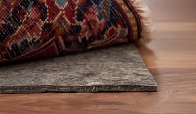 Rug pad under rug on wooden floor
