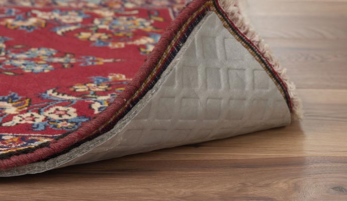 Rug pad installed underneath a rug