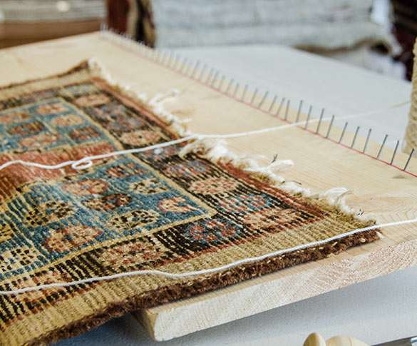 Frayed edges of rug.