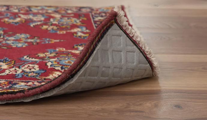 Rug with rug pad on wooden floor