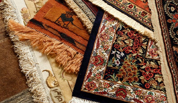 Stacked silk rugs with fringes