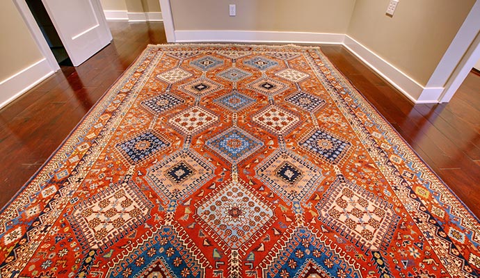Traditional antique rug on hardwood floor